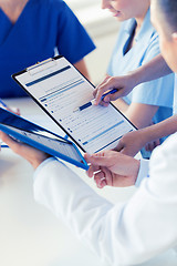 Image showing close up of doctors with clipboard at hospital