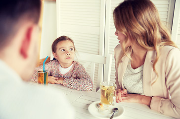 Image showing happy family having dinner at restaurant or cafe