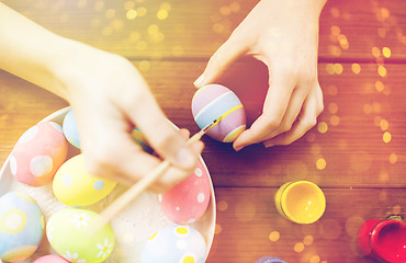 Image showing close up of woman hands coloring easter eggs