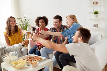 Image showing friends having party and clinking drinks at home