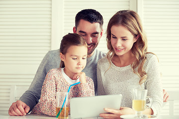 Image showing happy family with tablet pc at restaurant