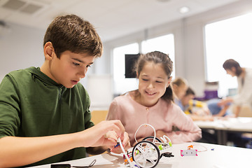 Image showing happy children building robots at robotics school