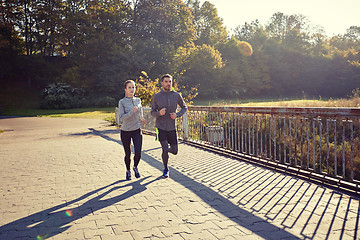 Image showing happy couple running outdoors