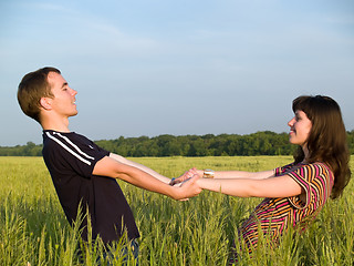 Image showing Teen Couple Holding Hands Field