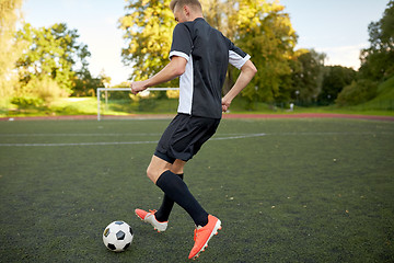 Image showing soccer player playing with ball on football field