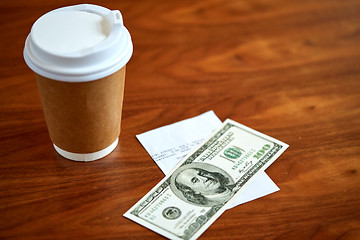 Image showing coffee in paper cup, bill and money on table