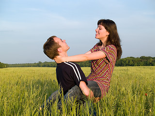 Image showing Young man Holding Wife in Field Smiling