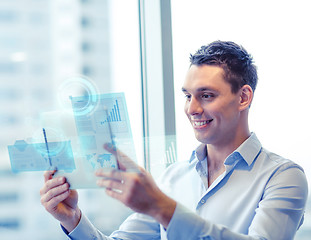 Image showing smiling businessman with tablet pc in office