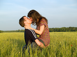 Image showing Teen Couple Kissing in Field