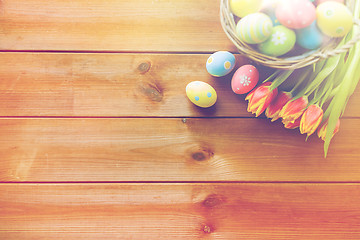 Image showing close up of easter eggs in basket and flowers