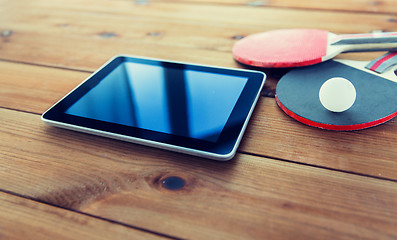 Image showing close up of table tennis rackets and tablet pc