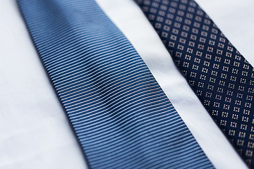 Image showing close up of shirt and blue patterned ties