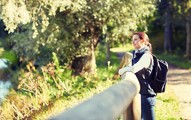 Image showing happy woman with backpack outdoors