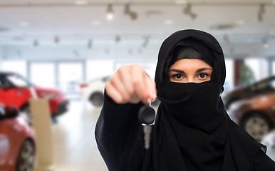 Image showing muslim woman in hijab with car key over car show