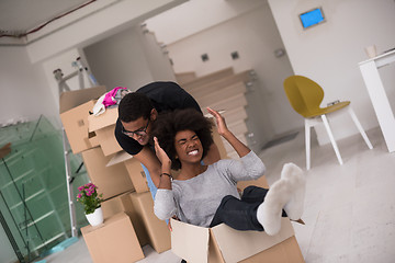 Image showing African American couple  playing with packing material