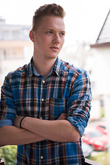 Image showing man standing at balcony