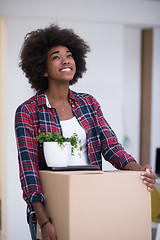 Image showing Black girl moving in the new apartment