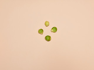 Image showing The piles of Brussels sprouts on a pink background