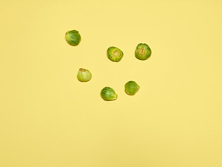 Image showing The piles of Brussels sprouts on a yellow background