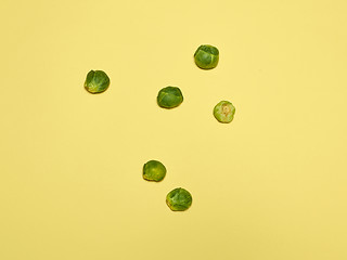 Image showing The piles of Brussels sprouts on a yellow background