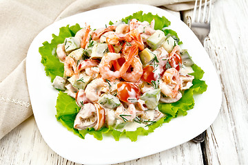 Image showing Salad with shrimp and tomatoes in plate on board