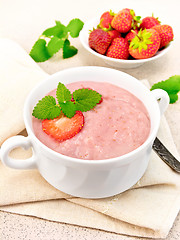 Image showing Soup strawberry in white bowl on napkin