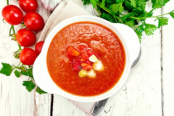 Image showing Soup tomato in white bowl with vegetables on board top