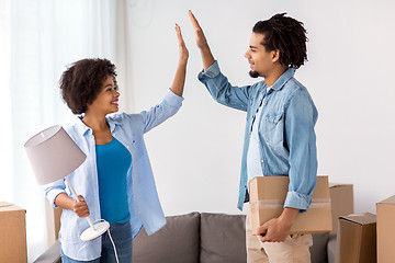 Image showing happy couple with stuff moving to new home