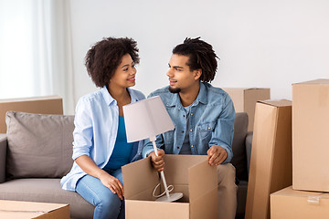 Image showing happy couple with stuff moving to new home