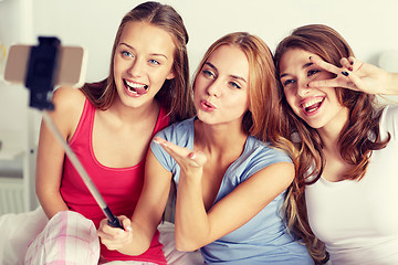 Image showing teen girls with smartphone taking selfie at home