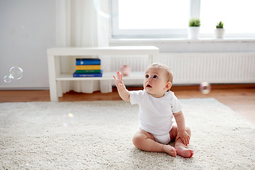 Image showing happy baby with soap bubbles at home