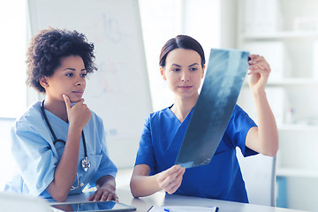 Image showing female doctors with x-ray image at hospital