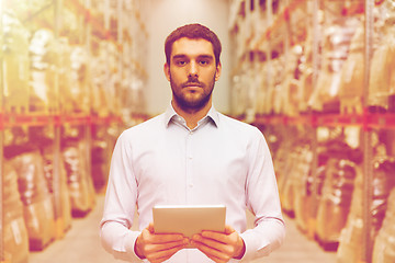 Image showing businessman with tablet pc at warehouse