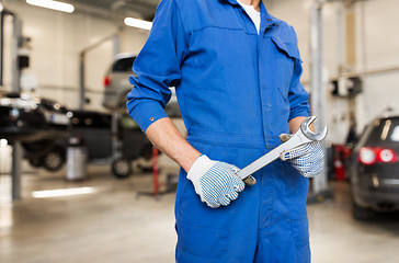 Image showing auto mechanic or smith with wrench at car workshop