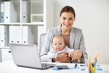 Image showing happy businesswoman with baby and laptop at office