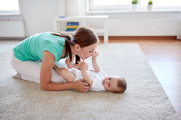 Image showing happy mother playing with baby at home