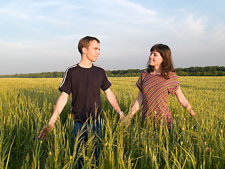 Image showing Young Couple Walking Field Holding Hands