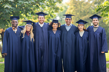 Image showing happy students or bachelors in mortar boards