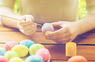 Image showing close up of woman hands coloring easter eggs