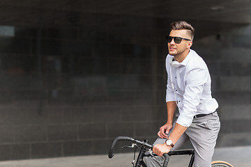 Image showing man with bicycle and headphones on city street