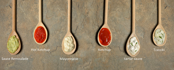 Image showing different types of sauces in spoons 