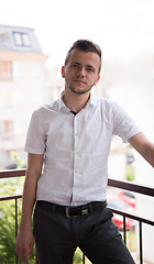 Image showing man standing at balcony