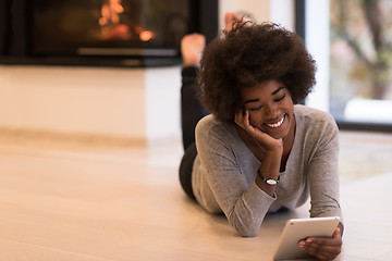 Image showing black women used tablet computer on the floor