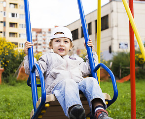 Image showing little cute boy playing on playground, hanging on gymnastic ring