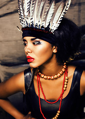 Image showing young pretty woman with make up like red indian, futher in hair,