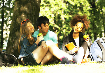 Image showing cute group of teenages at the building of university with books 