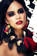 Image showing pretty brunette woman with rose jewelry, black and red, bright m