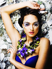 Image showing floral face art with anemone in jewelry, sensual young brunette 