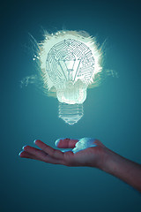 Image showing Hands of business person holding illuminated light bulb sign