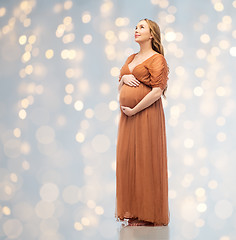 Image showing happy pregnant woman touching her big belly